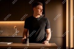 Man wearing black t shirt holding mug image Product Image 1