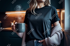 Woman holding warm beverage black t-shirt Product Image 1