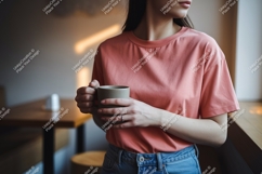 Woman holding mug wearing coral t-shirt image Product Image 1