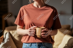 Woman holding coffee cup wearing terracotta t shirt Product Image 1