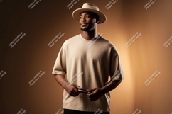 Man wearing beige t-shirt and hat holding Product Image 1