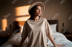 Woman wearing beige t shirt and hat image Product Image 1
