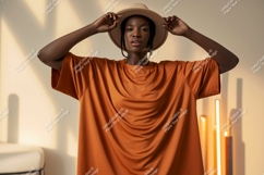 Woman wearing orange t shirt and hat fashion Product Image 1