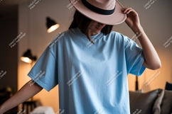 Woman wearing blue t-shirt and pink hat image Product Image 1