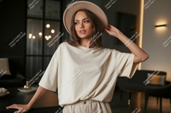 Woman wearing beige t shirt and hat image Product Image 1