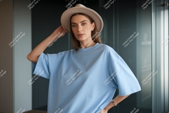 Woman wearing light blue t-shirt and hat fashion Product Image 1