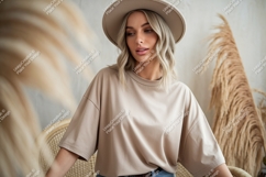 Blonde Woman Wearing Beige T Shirt and Hat Product Image 1