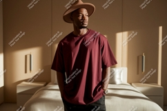 Man wearing maroon t shirt and hat image Product Image 1