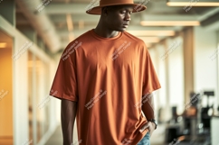Man wearing orange t shirt and hat t-shirt fashion Product Image 1
