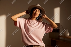 Woman wearing pink t-shirt and hat fashion Product Image 1