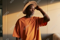 Man wearing orange t shirt and hat image Product Image 1