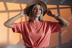 Woman wearing coral t shirt and hat Product Image 1