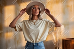 Blonde woman wearing cream t-shirt and hat Product Image 1