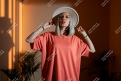 Woman wearing coral t shirt and hat image Product Image 1