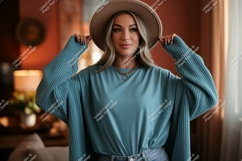 Woman wearing teal sweater and hat fashion Product Image 1