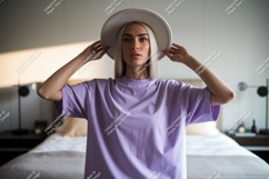 Blonde woman wearing lavender t-shirt and hat Product Image 1