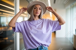 Woman wearing lavender t-shirt and hat blue Product Image 1