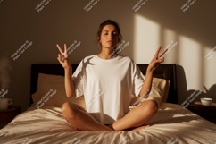Woman meditating on bed with peace signs meditation Product Image 1