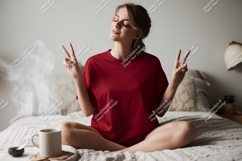 Woman in red shirt meditating on bed meditation Product Image 1