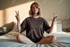 Woman peace sign gesture in bed indoors Product Image 1