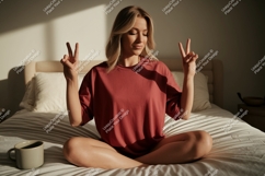 Blonde woman peace sign on bed image Product Image 1