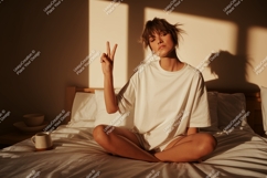 Woman peace sign in sunlit bedroom sunlight Product Image 1