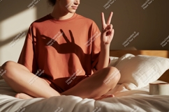 Person wearing terracotta t shirt making peace sign Product Image 1