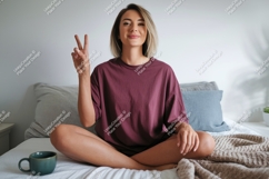Woman peace sign gesture on bed sitting Product Image 1