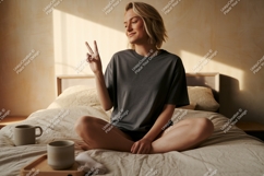 Woman peace sign seated bed image Product Image 1