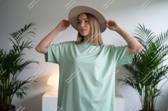 Woman wearing mint green t shirt and beige hat image Product Image 1