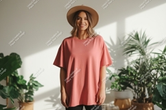 Woman wearing salmon pink t shirt and hat image Product Image 1