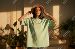 Woman wearing mint green t shirt and hat image Product Image 1