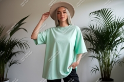 Woman wearing mint green oversized t-shirt and hat Product Image 1