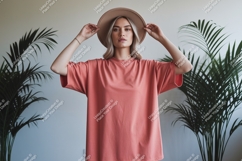 Woman wearing coral t shirt and hat image Product Image 1