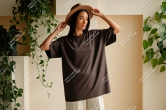 Woman wearing brown t shirt and hat image Product Image 1