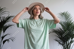 Woman wearing mint green t-shirt and hat Product Image 1