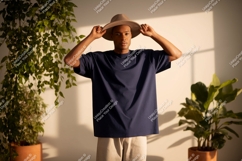 Man wearing hat and navy t-shirt plants Product Image 1