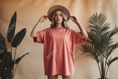 Woman wearing coral oversized t shirt and hat image Product Image 1