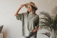 Woman wearing green t-shirt and hat Product Image 1
