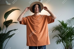 Man wearing orange t shirt and hat image Product Image 1