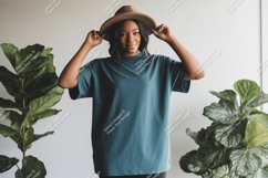 Woman wearing teal t shirt and brown hat t-shirt Product Image 1