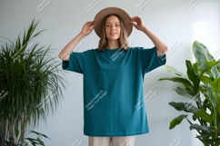 Woman wearing teal t shirt and hat image Product Image 1