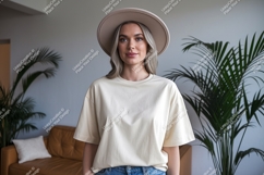 Woman wearing beige t shirt and hat image Product Image 1