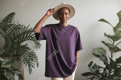 Woman wearing purple t shirt and hat image Product Image 1