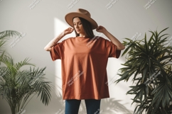 Woman wearing terracotta t-shirt and hat Product Image 1