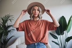 Woman wearing terracotta t-shirt and hat Product Image 1