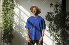 Man wearing blue t-shirt and hat plants Product Image 1