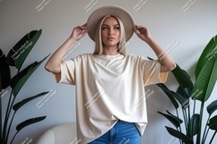 Woman wearing oversized cream t shirt and hat image Product Image 1
