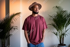 Man wearing maroon t-shirt and hat Product Image 1