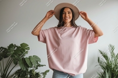 Woman wearing pink t shirt and hat image Product Image 1